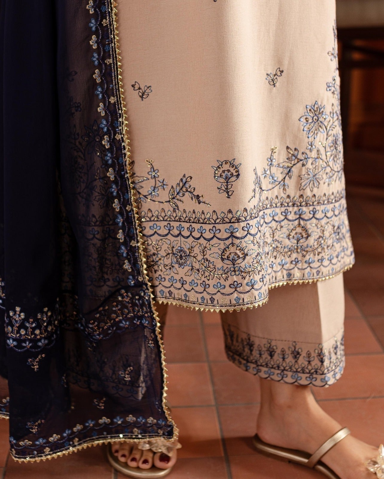 Traditional embroidered outfit with a focus on intricate patterns.